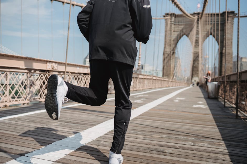 A person jogging on the iconic Brooklyn Bridge in New York City, showcasing urban fitness lifestyle.