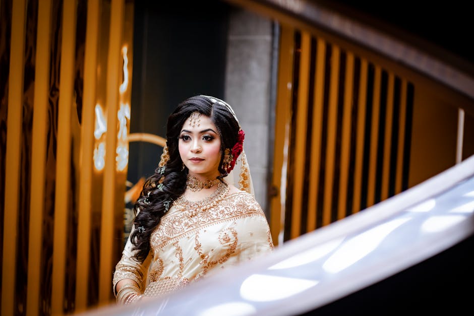 A stunning South Asian bride in a traditional saree with floral accessories.
