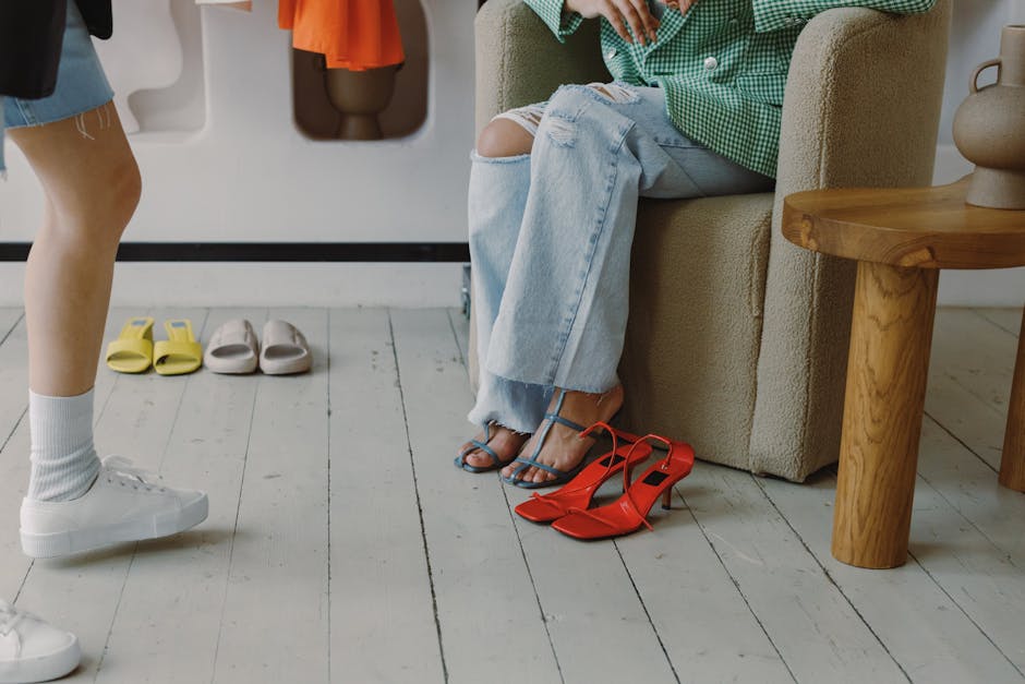 A stylish scene showcasing ripped jeans, vibrant shoes, and modern casual fashion indoors.